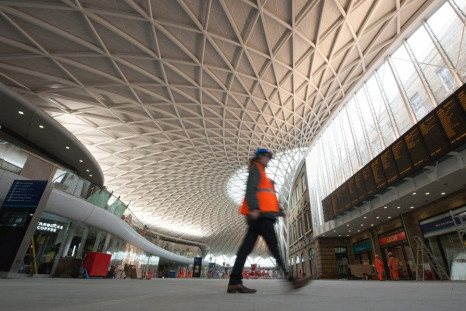 A worker walks in the new Kings Cross rail station redevelopment in London