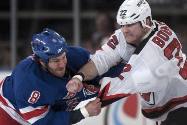 Brandon Proust and Eric Boulton square off in a pre-arranged fight at the start of a game between the Rangers and Devils.