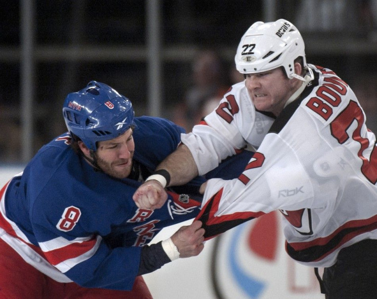 Brandon Proust and Eric Boulton square off in a pre-arranged fight at the start of a game between the Rangers and Devils.