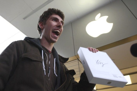 Goran Marberg holds his new iPad, autographed by Apple co-founder Steve Wozniak who, with his wife Janet, waited in line overnight with customers at the Apple Store in Century City Westfield Shopping Mall in Los Angeles, California March 16, 2012.