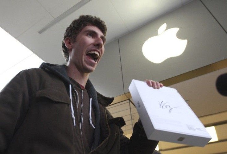 Goran Marberg holds his new iPad, autographed by Apple co-founder Steve Wozniak who, with his wife Janet, waited in line overnight with customers at the Apple Store in Century City Westfield Shopping Mall in Los Angeles, California March 16, 2012.