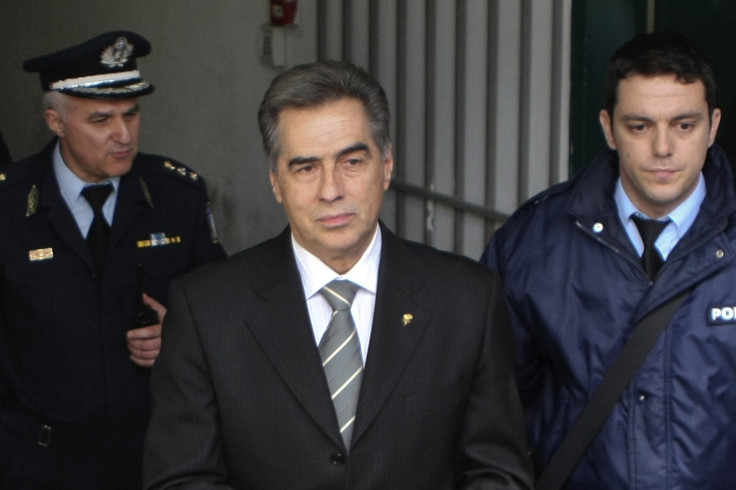 Vassilis Papageorgopoulos, former mayor of Thessaloniki, Greece's largest second city, is escorted by policemen as he leaves a courthouse in Thessaloniki February 27, 2013.