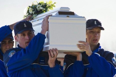 Police officers carrying coffin of a victim of Swiss bus crash