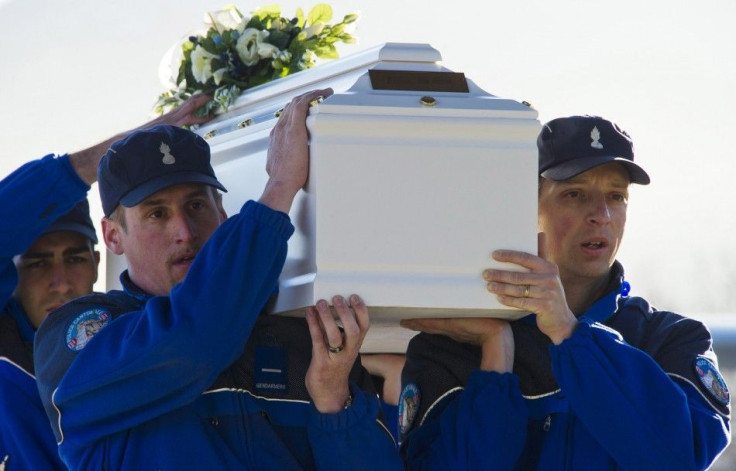 Police officers carrying coffin of a victim of Swiss bus crash