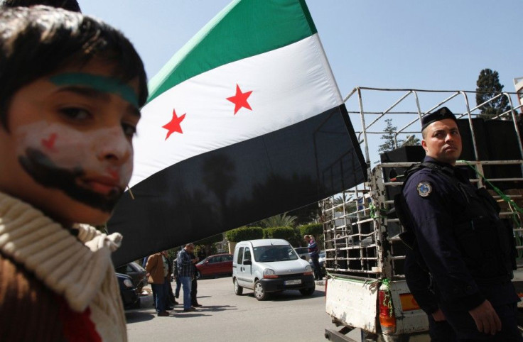 A refugee who recently fled from Syria attends a demonstration in solidarity with Syrians against the regime, in Tripoli