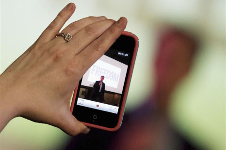 A woman takes a video with her iPhone as Republican presidential candidate and former U.S. Senator Rick Santorum addresses supporters at a Get Out The Vote rally in Mandeville, Louisiana March 21, 2012.
