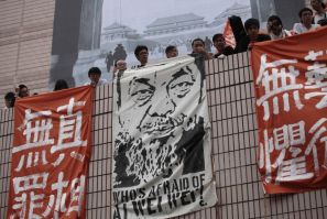 Artists hold banners including one featuring a portrait of detained Chinese artist Ai Weiwei during a protest in Hong Kong.
