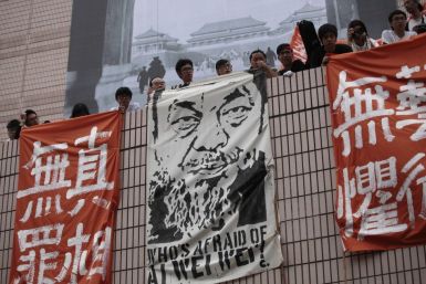 Artists hold banners including one featuring a portrait of detained Chinese artist Ai Weiwei during a protest in Hong Kong.