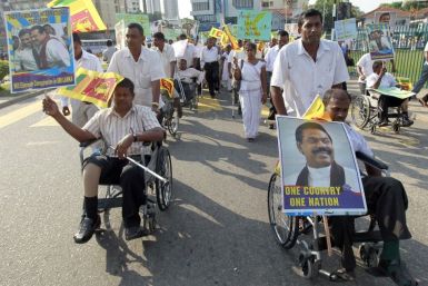 Handicapped Sri Lankan soldiers in wheelchairs call for the defeat of a U.N. resolution urging Sri Lanka to probe wartime human rights abuses in Colombo