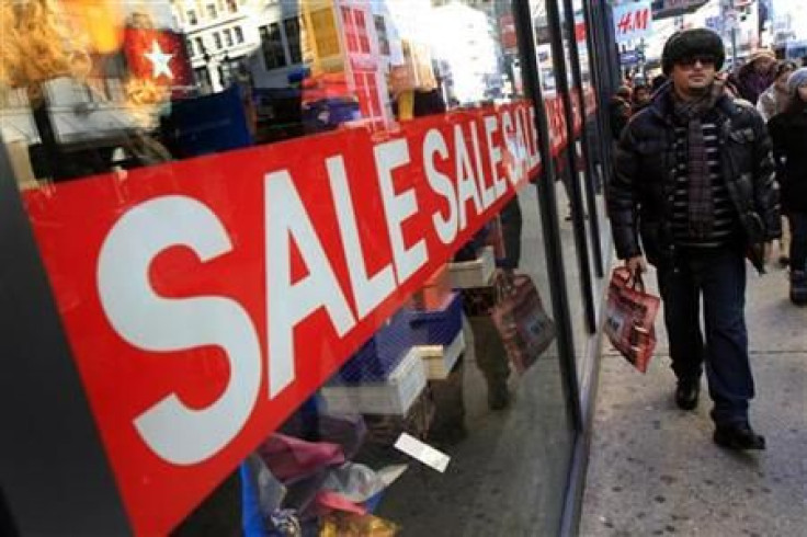 A holiday shopper passes a sale sign at a clothing store in New York