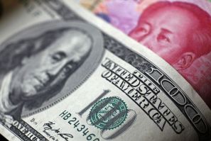 File photo of a Chinese 100 yuan banknote being placed under a $100 banknote in this photo illustration taken in Beijing