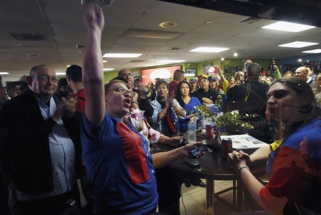 A crowd cheers at a restaurant in Florida