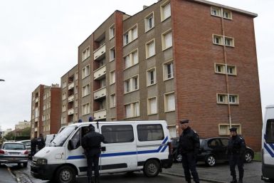 Police secure the street outside the five-storey apartment building where earlier special forces police staged the assault on the gunman Mohamed Merah in Toulouse