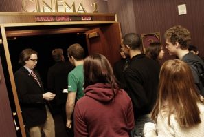 Movie attendees enter a theater on the opening night of &quot;The Hunger Games&quot; at Regal Cinemas in Los Angeles, California March 22, 2012. 