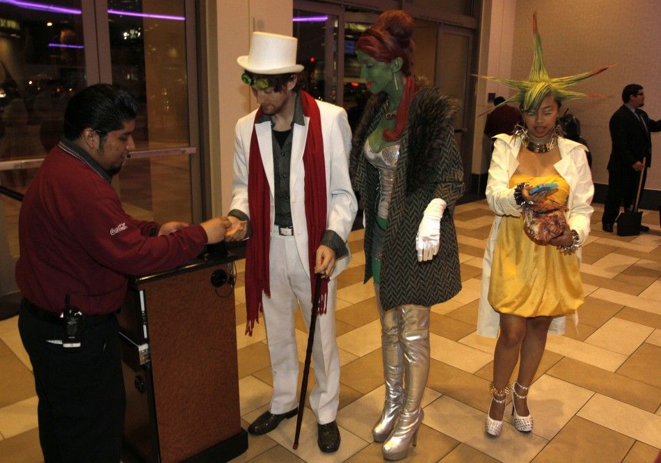 Movie attendees dressed as characters in quotThe Hunger Gamesquot arrive for the midnight screening on opening night at Regal Cinemas in Los Angeles, California March 22, 2012. 