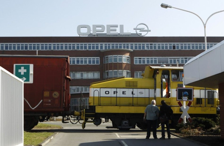Workers wait in front of the Opel plant of Bochum