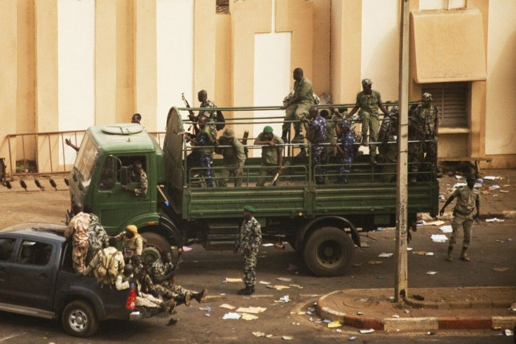 Malian soldiers and security forces gather at the offices of the state radio and television broadcaster after announcing a coup d'etat in the capital Bamako