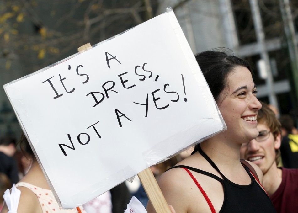 A woman holds up a sign during a SlutWalk rally against sexual abuse and inequality in Brussels
