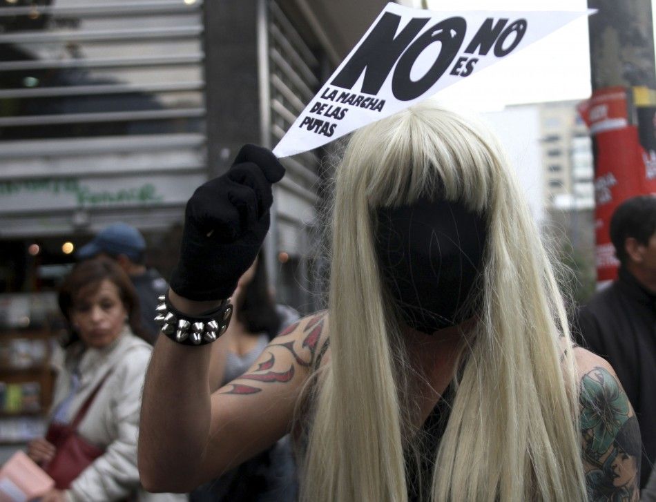 Man in a wig and mask takes part in a quotMarch of the whoresquot to protest against discrimination and violence against women in Bogota