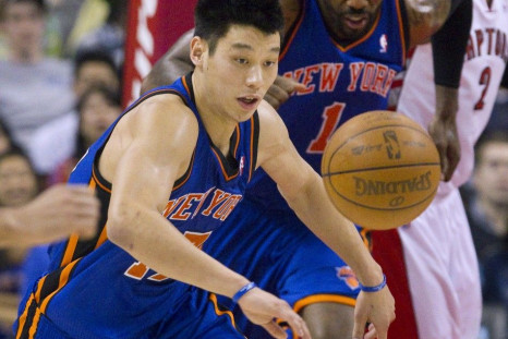 Jeremy Lin chases a loose ball in the first half of their NBA basketball game against the Toronto Raptors in Toronto March 23, 2012.