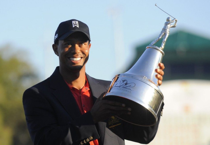 Tiger Woods holds the trophy after winning the Arnold Palmer Invitational PGA golf tournament in Orlando.