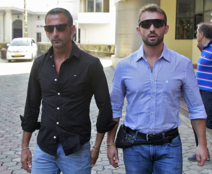 Italian sailors Salvatore Girone (R) and Massimiliano Latorre leave the police commissioner office in the southern Indian city of Koch