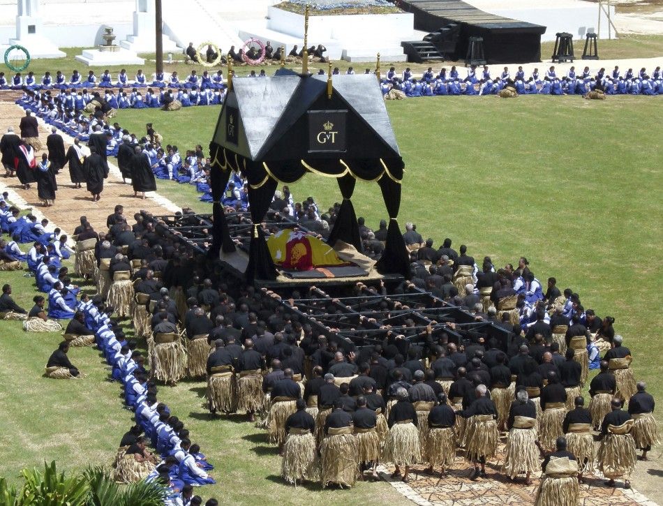 A coffin carrying Tongas King George Tupou V is carried on a giant black and gold-topped catafalque by 150 pallbearers to the Royal Tombs in Tongas capital Nukualofa March 27, 2012
