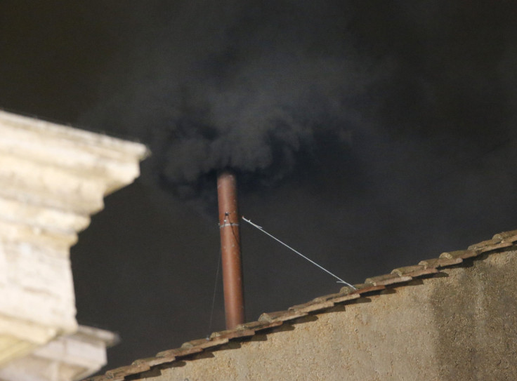 Black smoke rises from the chimney on the roof of the Sistine Chapel in the Vatican City indicating that no decision has been made after the first day of voting for the election of a new pope.