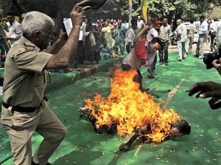 Tibetan activist and exile Jamphel Yeshi, 27, lies on the ground burning