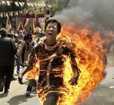 Tibetan activist and exile Jamphel Yeshi, 27, runs through the streets on fire