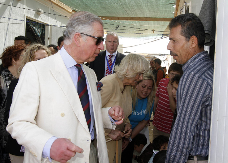 Prince Charles talks with a Syrian refugee in a Jordan Camp