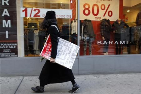 A woman walks past a retail store in the fashion district of New York