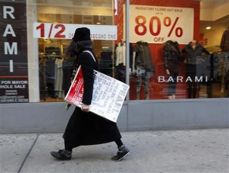 A woman walks past a retail store in the fashion district of New York