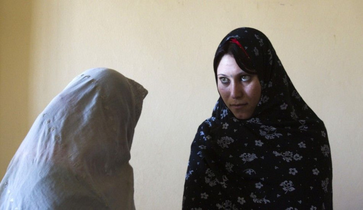 Afghan female prisoners stand in their cell at a prison in Herat