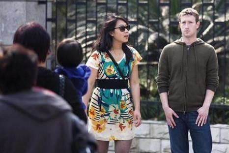 Facebook CEO Mark Zuckerberg (R) and his girlfriend Priscilla Chan walk near Fuxing Road in Shanghai March 27, 2012. Zuckerberg and his girlfriend were visiting Shanghai, according to local media reports. Picture taken on March 27, 2012.