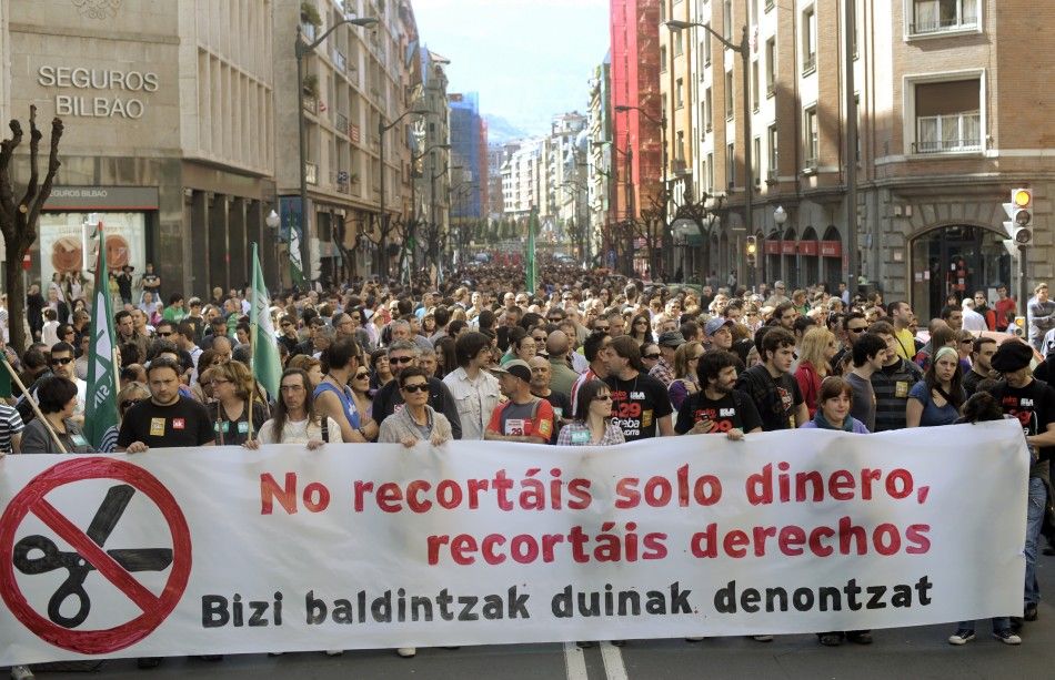 Protesters carry a banner reading quotYou are not just cutting our money, you are cutting our rightsquot during a march in Bilbao.