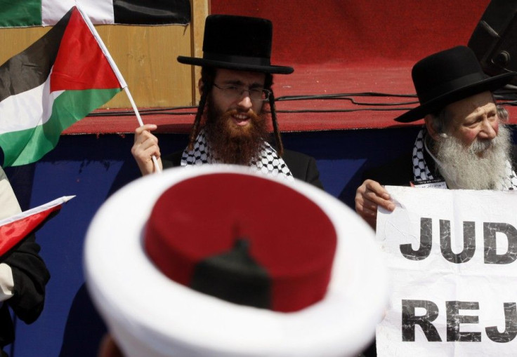 Delegate of Neturei Karta waves a Palestinian flag at rally in solidarity with Hezbollah and Palestinian factions for a &quot;Global March to Jerusalem&quot; to mark Land Day in Arnoun village