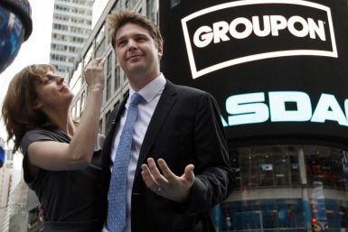 Groupon Inc. CEO Andrew Mason poses with his newly married wife, pop musician Jenny Gillespie, outside the Nasdaq Market following his company's IPO in New York, November 4, 2011.