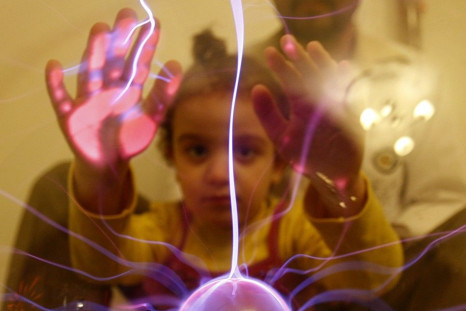 An autistic child touches an electric globe at the Consulting Centre for Autism in Amman