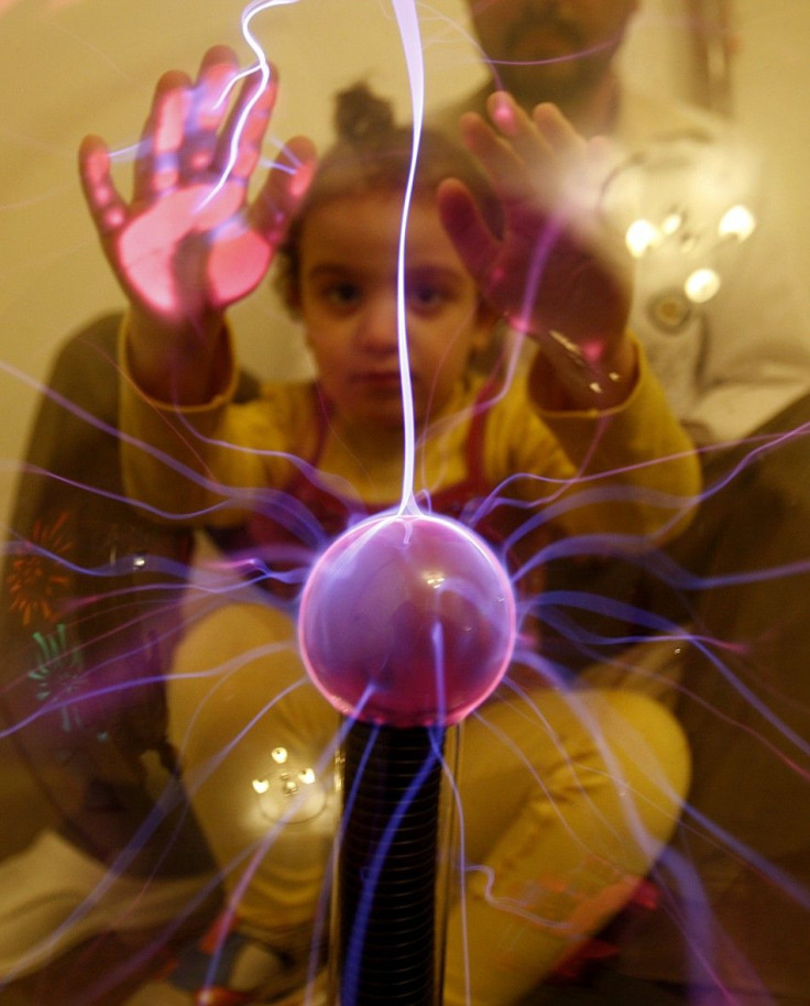 An autistic child touches an electric globe at the Consulting Centre for Autism in Amman