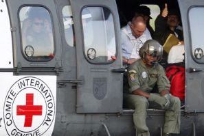 A Colombian policeman recently freed by FARC rebels sits on a Brazilian army helicopter after being freed, at Villavicencio&#039;s airport