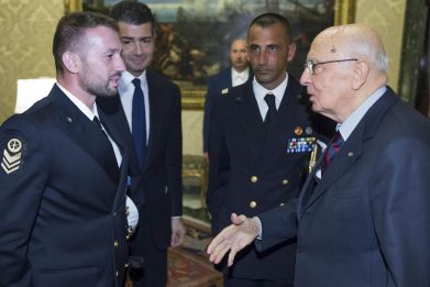 Italian President Giorgio Napolitano (R) greets two Italian marines Salvatore Girone (L) and Massimiliano Latorre (2nd R) during a meeting at Quirinale presidential palace in Rome, December 22, 2012. 