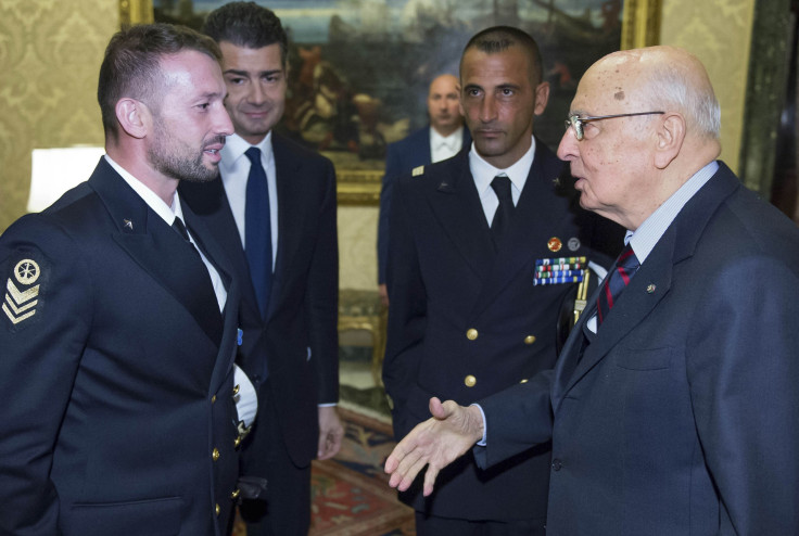 Italian President Giorgio Napolitano (R) greets two Italian marines Salvatore Girone (L) and Massimiliano Latorre (2nd R) during a meeting at Quirinale presidential palace in Rome, December 22, 2012. 