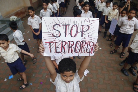 A student lifts a placard as he and others line up to take part in a march for peace in Mumbai