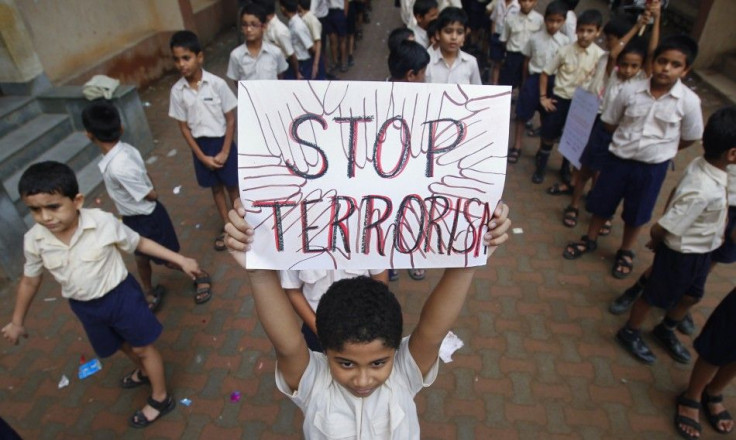 A student lifts a placard as he and others line up to take part in a march for peace in Mumbai