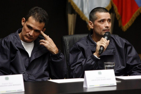 Policemen Jorge Trujillo Solarte and Carlos Jose Duarte, who were part of group of hostages freed after being held for more than a decade by FARC rebels, attend a news conference in Bogota