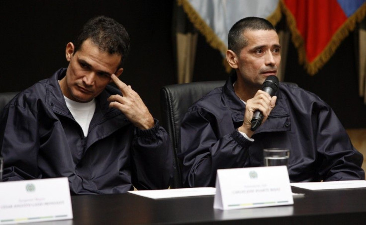 Policemen Jorge Trujillo Solarte and Carlos Jose Duarte, who were part of group of hostages freed after being held for more than a decade by FARC rebels, attend a news conference in Bogota