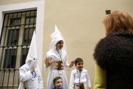 Penitents of &quot;La Candelaria&quot; brotherhood walk to their churchduring Holy Week in Seville