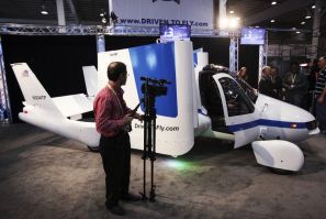 A man films aircraft company Terrafugia's flying car, called the Transition, at the 2012 International Auto Show in New York