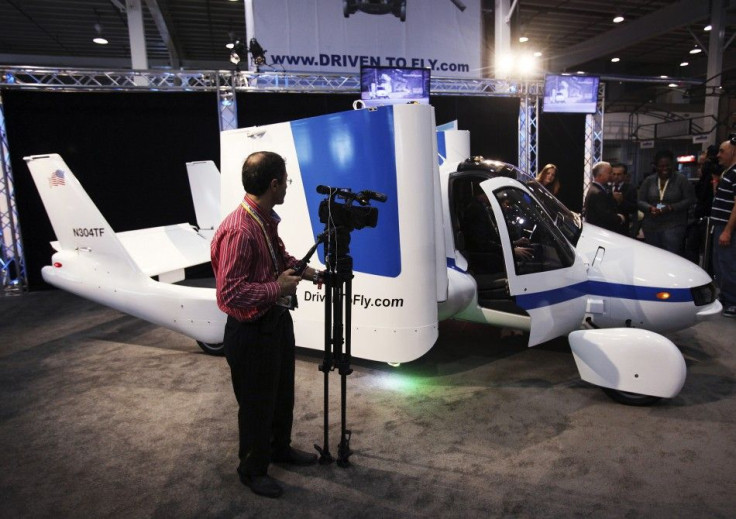 A man films aircraft company Terrafugia's flying car, called the Transition, at the 2012 International Auto Show in New York